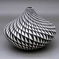 A black on white jar decorated with a spiral mesa geometric design
 by Sandra Victorino of Acoma