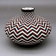 A polychrome jar with a short neck and pie crust rim, decorated with a lightning bolt and geometric design
 by Paula Estevan of Acoma