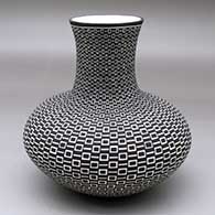A black on white vase decorated with a geometric design
 by Paula Estevan of Acoma