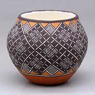 A small polychrome jar decorated around the body with a fineline, basket weave and geometric design
 by Amanda Lucario of Acoma