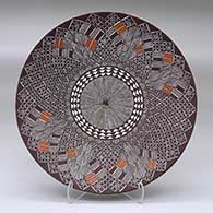 A polychrome plate decorated with a fineline and geometric design
 by Amanda Lucario of Acoma