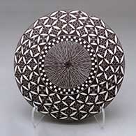 A black on white seed pot decorated above the shoulder with a fineline, yucca leaf snowflake, checkerboard and geometric design
 by Amanda Lucario of Acoma