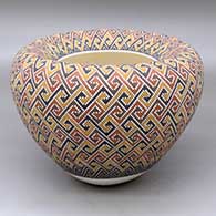 A polychrome jar with an Infinity rim and decorated with a tiny square geometric design
 by Frederica Antonio of Acoma