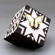 A polychrome lidded box decorated with a butterfly and geometric design
 by Charmae Natseway of Acoma