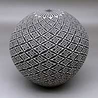 A black on White seed pot decorated with a geometric design
 by Cletus Victorino of Acoma