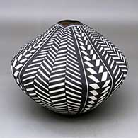 A black on white seed pot with a squarish opening and decorated with a basketweave geometric design
 by Sandra Victorino of Acoma