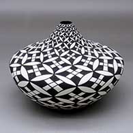 A black on white squash jar with a narrow opening and decorated with a yucca leaf snowflake and geometric design
 by Sandra Victorino of Acoma