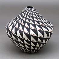 A polychrome jar with a narrow opening and decorated with a spiral mesa and snowflake geometric design
 by Sandra Victorino of Acoma