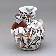 A small polychrome jar with a boy and cat perched on the shoulder and a bird on the rim and decorated with a lizard and geometric design
 by Judy Lewis of Acoma