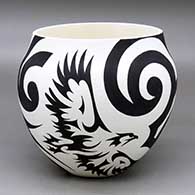 A black on white jar decorated with an eagle and flowing geometric design
 by Eric Lewis of Acoma