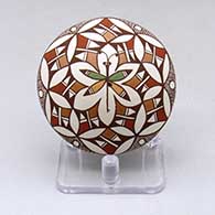 A polychrome seed pot decorated with a dragonfly and geometric design
 by Diane Lewis of Acoma