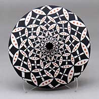 A polychrome seed pot decorated with a pumpkin seed, snowflake and geometric design
 by Dorothy Torivio of Acoma