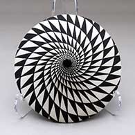 A black on white tear drop jar decorated with a spiral mesa geometric design
 by Dorothy Torivio of Acoma