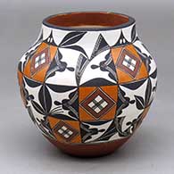 A small jar decorated with a geometric design taken from a 1850s Acoma water jar
 by Lilly M Salvador of Acoma