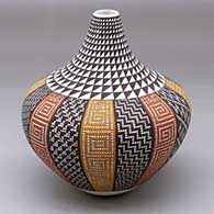 A tall, thin-necked jar decorated with a 16-panel tiny square geometric design and a spiral mesa design on the neck
 by Frederica Antonio of Acoma