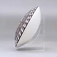 A polychrome seed pot decorated on top with a fineline and geometric design, click or tap to see a larger version