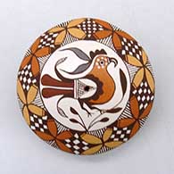 A polychrome seed pot decorated on top with a parrot, yucca-leaf snowflake, fineline and geometric design
 by Diane Lewis of Acoma