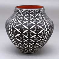 A polychrome jar decorated with a four panel fineline, pumpkin seed snowflake and geometric design
 by Sandra Victorino of Acoma