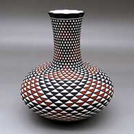 A tall neck polychrome vase with a pie crust rim and decorated with a spiral mesa geometric design
 by Paula Estevan of Acoma