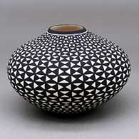 A black on white jar decorated with a geometric design
 by Paula Estevan of Acoma