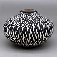 A black on white jar decorated with a lightning bolt geometric design
 by Paula Estevan of Acoma