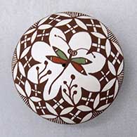 A polychrome seed pot decorated with a dragonfly and geometric design
 by Diane Lewis of Acoma