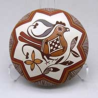 A polychrome seed pot decorated with a bird, branch and geometric design
 by Diane Lewis of Acoma