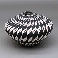 A polychrome jar decorated with a snowflake and spiral checkerboard geometric design
 by Sandra Victorino of Acoma