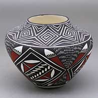 A polychrome jar decorated with a fineline, spiral, feather and geometric design
 by Sandra Victorino of Acoma