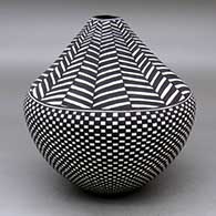 A black on white jar with a small, square opening and decorated with a checkerboard and geometric design
 by Sandra Victorino of Acoma