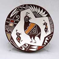 A small polychrome plate decorated with quail head and lady bug appliques and a painted quail family, lady bug, fineline and geometric design
 by Carolyn Concho of Acoma