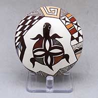 A polychrome seed pot decorated with turtle head and lady bug appliques and a painted turtle, lady bug, fineline and geometric design
 by Carolyn Concho of Acoma