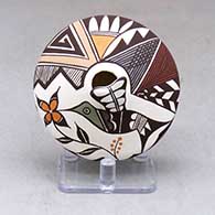 A polychrome seed pot decorated with hummingbird wing and lady bug appliques and a painted hummingbird, flower, lady bug, fineline and geometric design
 by Carolyn Concho of Acoma