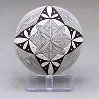 A polychrome seed pot decorated with a fineline and geometric design above the shoulder and with a painted butterfly applique on the back
 by Alisha Sanchez of Acoma