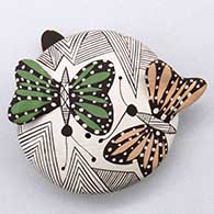 A miniature polychrome seed pot decorated with painted butterfly appliques and a fineline and geometric design
 by Alisha Sanchez of Acoma