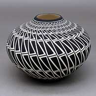 A black on white jar decorated with a locks and keys geometric design
 by Paula Estevan of Acoma