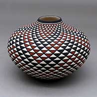 A polychrome jar decorated with a spiral mesa geometric design
 by Paula Estevan of Acoma