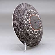 A polychrome seed pot decorated above the shoulder with a North Star fineline and geometric design, click or tap to see a larger version