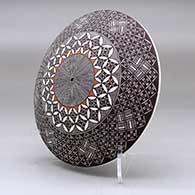 A polychrome seed pot decorated above the shoulder with a North Star fineline and geometric design, click or tap to see a larger version