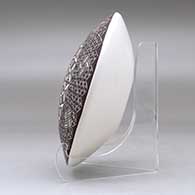 A polychrome seed pot decorated above the shoulder with a North Star fineline and geometric design, click or tap to see a larger version