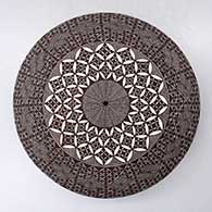 A black on white seed pot decorated above the shoulder with a North Star fineline and geometric design
 by Rebecca Lucario of Acoma