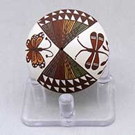 A miniature polychrome seed pot decorated with a dragonfly, butterfly, fineline and geometric design
 by Diane Lewis of Acoma