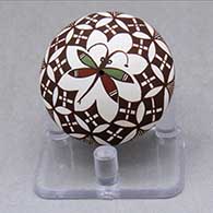 A miniature polychrome seed pot decorated with a dragonfly and geometric design
 by Diane Lewis of Acoma