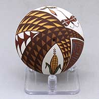 A miniature polychrome seed pot decorated above the shoulder with an ear of corn, dragonfly and geometric design
 by Diane Lewis of Acoma