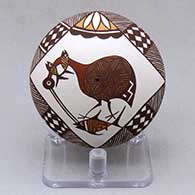 A miniature polychrome seed pot decorated above the shoulder with a cloudeater, fish, fineline and geometric design
 by Diane Lewis of Acoma