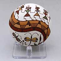 A miniature polychrome seed pot decorated above the shoulder with a pueblo dancer, dragonfly, plant and geometric design
 by Diane Lewis of Acoma
