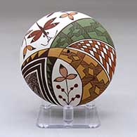 A polychrome seed pot decorated above the shoulder with a dragonfly, flower and geometric design
 by Diane Lewis of Acoma