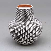 A small polychrome jar decorated with a spiral mesa geometric design
 by Frederica Antonio of Acoma
