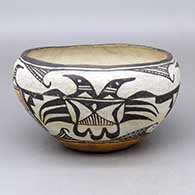 A polychrome bowl decorated around the outside with a four panel thunderbird and geometric design
 by Unknown of Acoma