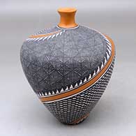 A polychrome thin neck vase decorated with a four panel spiraling checkerboard, fineline and geometric design
 by Sandra Victorino of Acoma